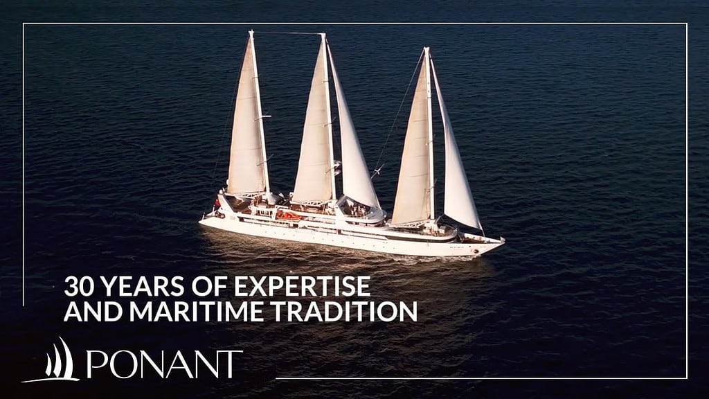 A Ponant expedition ship in a remote coastal landscape